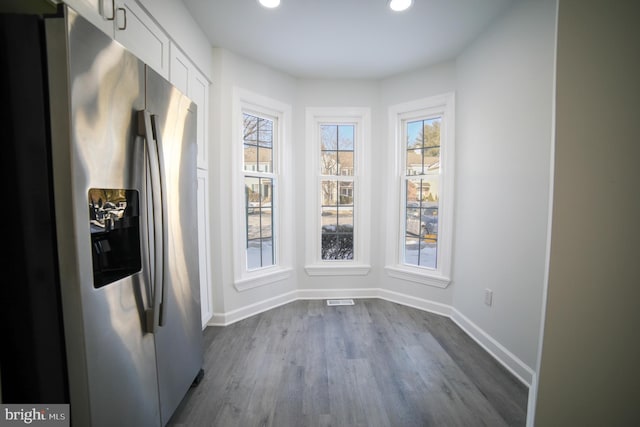 unfurnished dining area with dark hardwood / wood-style flooring and a wealth of natural light