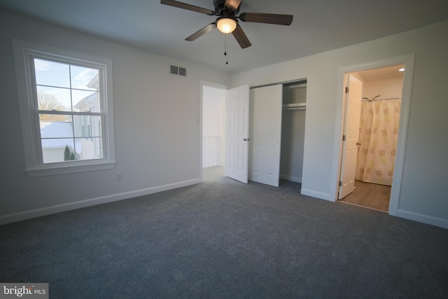 unfurnished bedroom featuring dark carpet, a closet, and ceiling fan