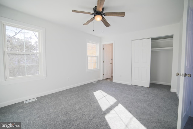 unfurnished bedroom featuring carpet floors, a closet, and ceiling fan