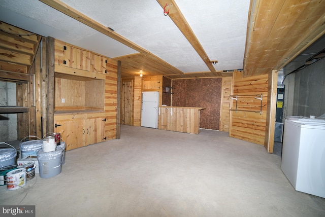 interior space with washer / dryer and wooden walls