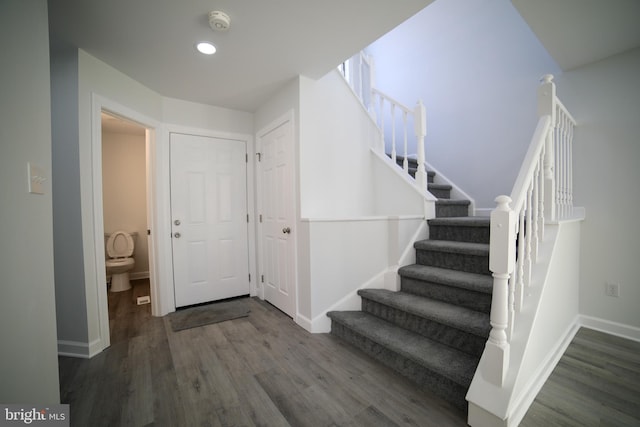 stairs with hardwood / wood-style floors