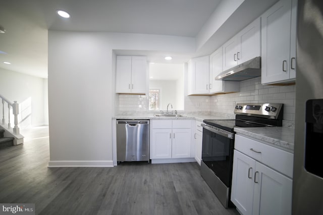 kitchen with sink, wood-type flooring, white cabinets, and appliances with stainless steel finishes