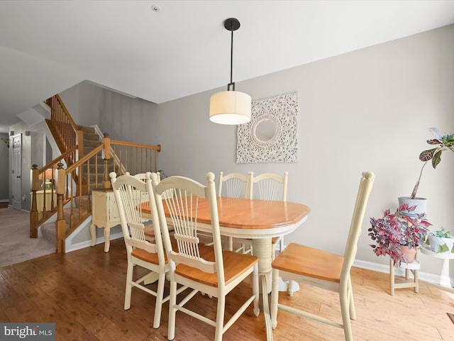 6422 Frothingham Ct, Elkridge, MD 21075 - dining space featuring wood finished floors, stairs, and baseboards