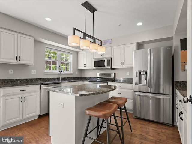 6422 Frothingham Ct, Elkridge, MD 21075 - kitchen featuring appliances with stainless steel finishes, white cabinets, dark stone counters, a sink, and recessed lighting