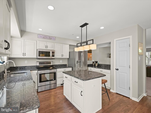 6422 Frothingham Ct, Elkridge, MD 21075 - kitchen with stainless steel appliances, a sink, white cabinets, recessed lighting, and wood finished floors