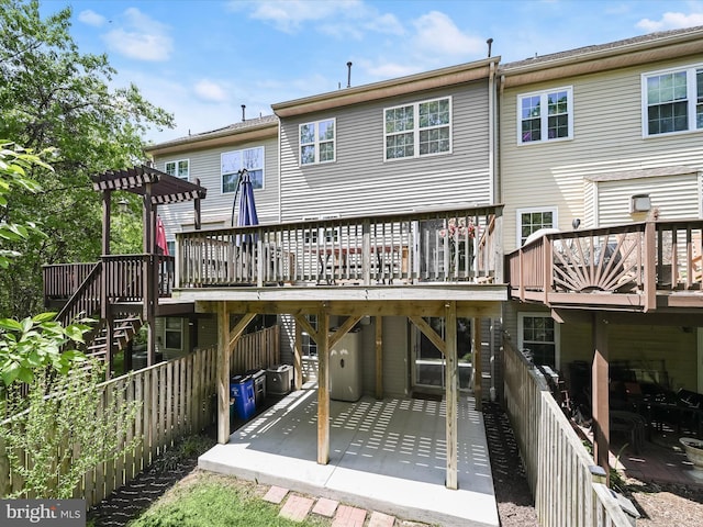 6422 Frothingham Ct, Elkridge, MD 21075 - back of property featuring a wooden deck and a patio