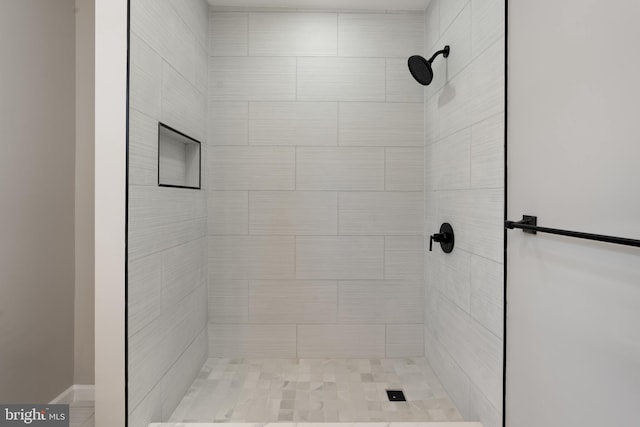 bathroom with a tile shower