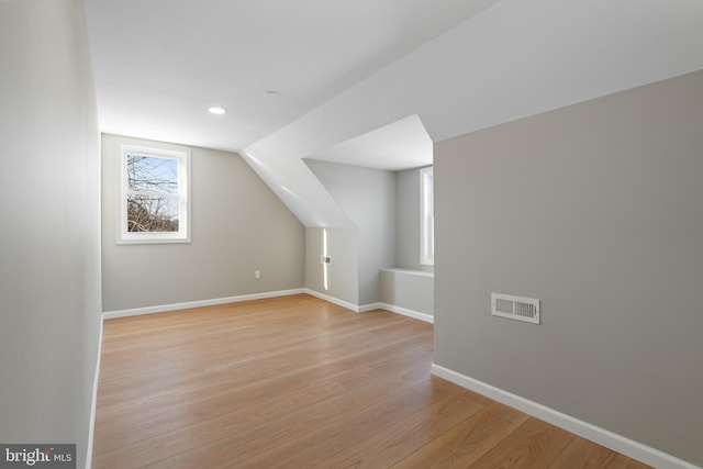 bonus room featuring vaulted ceiling and light hardwood / wood-style floors