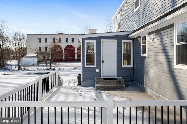 view of snow covered property entrance