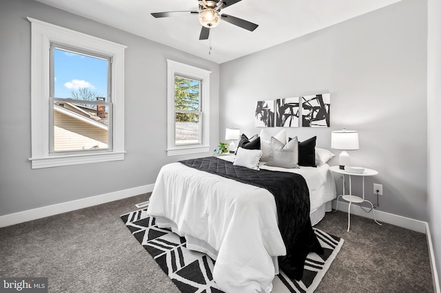 carpeted bedroom featuring ceiling fan and multiple windows