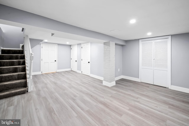 basement with light hardwood / wood-style floors