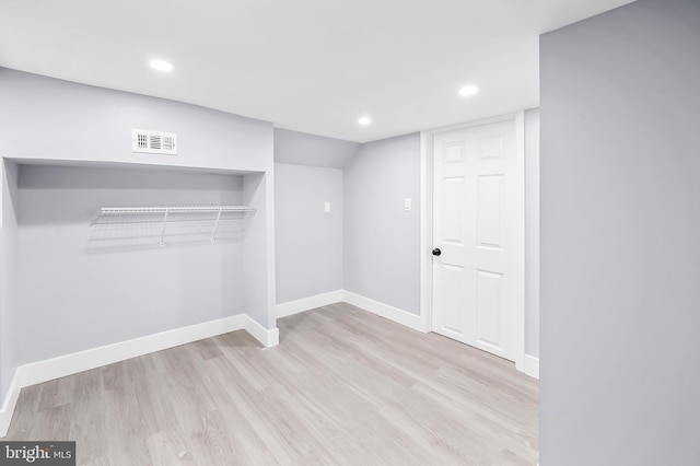 basement with light hardwood / wood-style floors