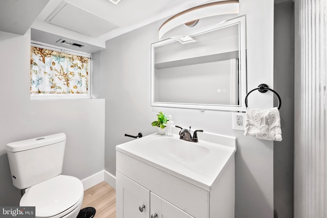 bathroom featuring vanity, hardwood / wood-style floors, and toilet