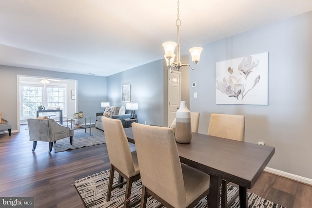 dining room with a chandelier and dark hardwood / wood-style flooring