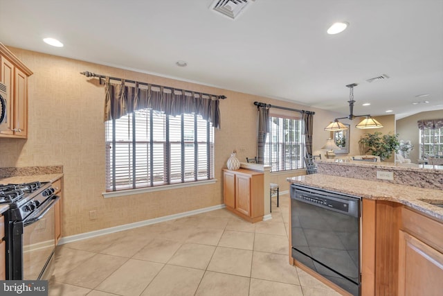 kitchen featuring hanging light fixtures, light tile patterned flooring, light stone countertops, and black appliances