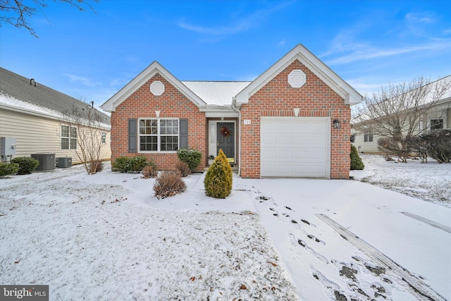 view of front of home featuring a garage and central air condition unit