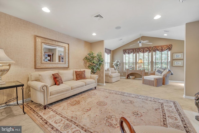 living room with ceiling fan, vaulted ceiling, and light tile patterned floors