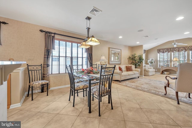 tiled dining area featuring vaulted ceiling and ceiling fan