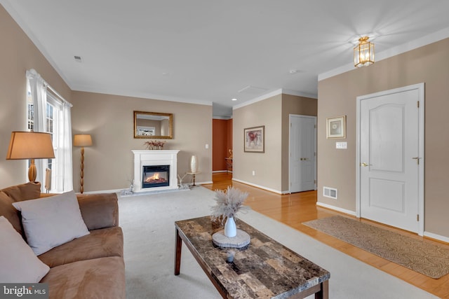 living room featuring crown molding and light wood-type flooring