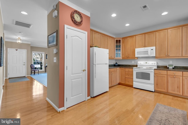 kitchen with white appliances and light hardwood / wood-style flooring