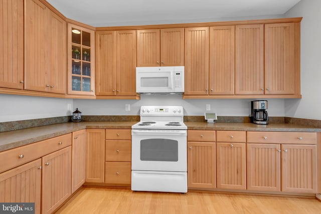 kitchen with white appliances and light hardwood / wood-style floors