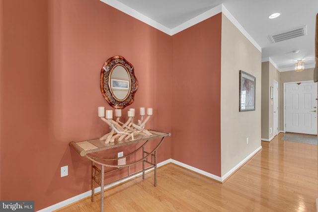 hall with crown molding and hardwood / wood-style flooring