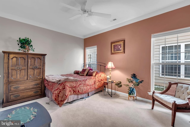 bedroom featuring light colored carpet and ceiling fan