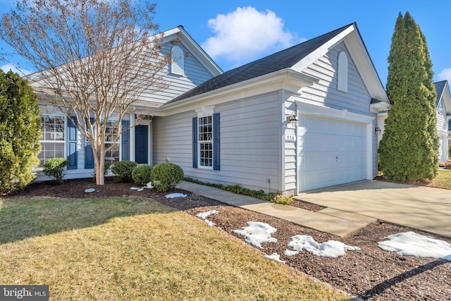 view of front of home with a garage and a front yard