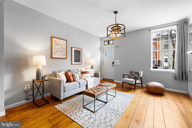 living room featuring hardwood / wood-style floors and an inviting chandelier