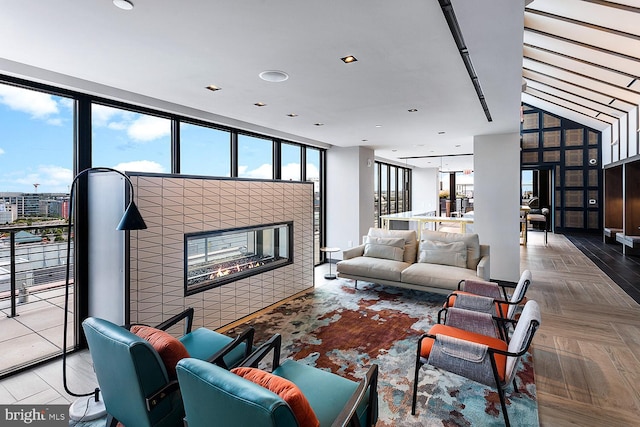 living room with a tiled fireplace and parquet flooring