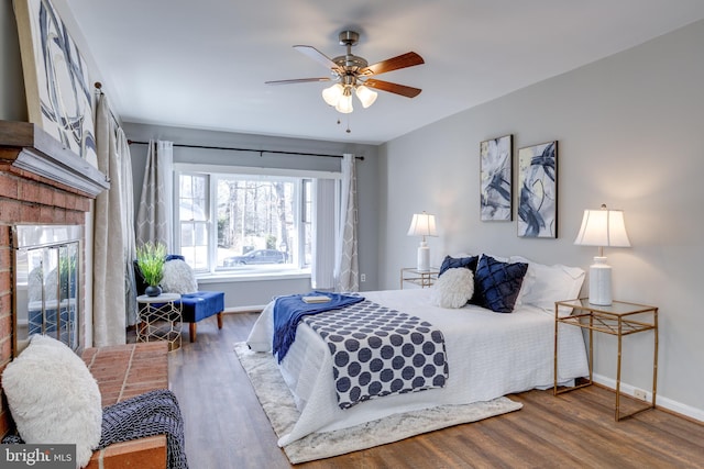 bedroom with baseboards, a ceiling fan, and wood finished floors