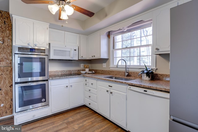 kitchen featuring ceiling fan, dark wood finished floors, a sink, stainless steel appliances, and white cabinetry