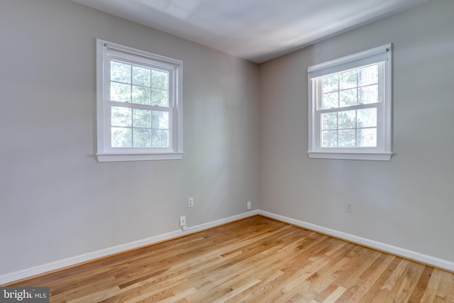 empty room featuring baseboards and wood finished floors