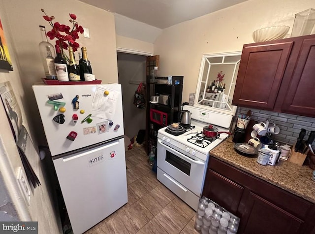 kitchen with white appliances, light stone countertops, and decorative backsplash