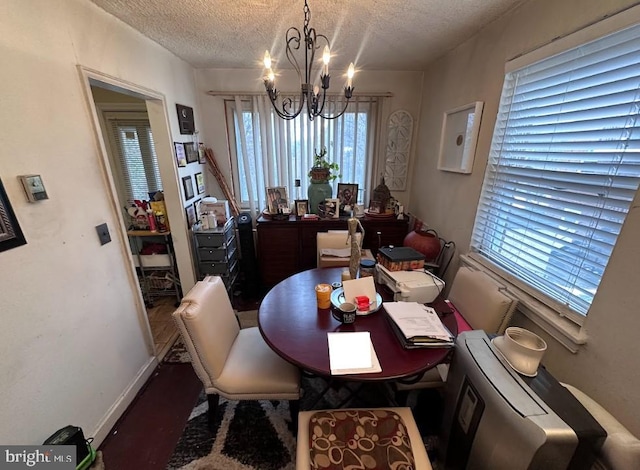 dining room featuring an inviting chandelier and a textured ceiling