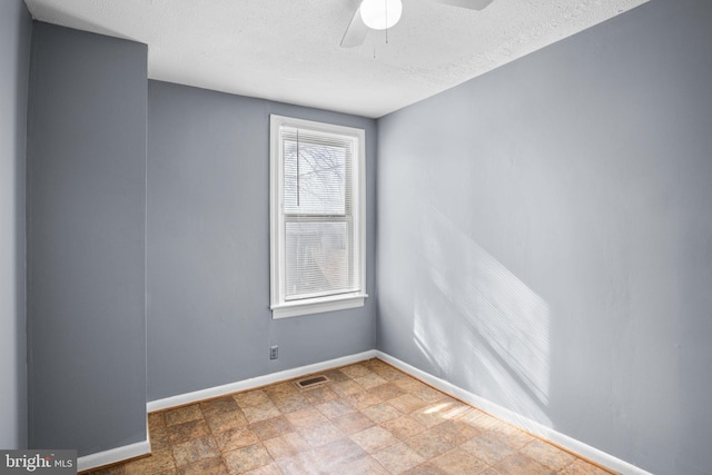 empty room featuring ceiling fan and a textured ceiling