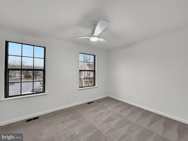 carpeted empty room featuring ceiling fan