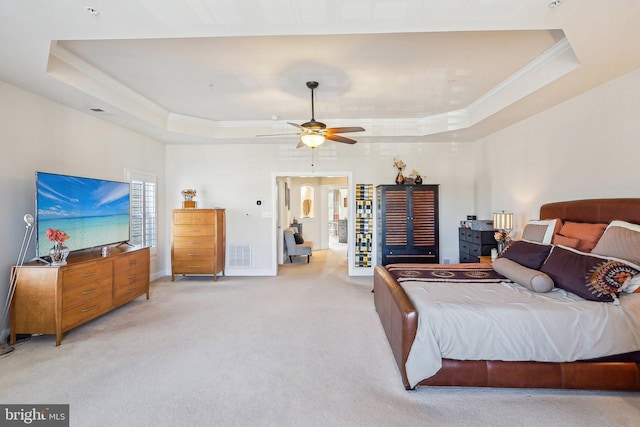 bedroom featuring light carpet, crown molding, a raised ceiling, and ceiling fan