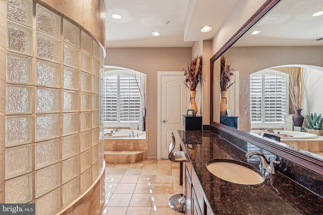 bathroom featuring vanity, tiled bath, and tile patterned floors