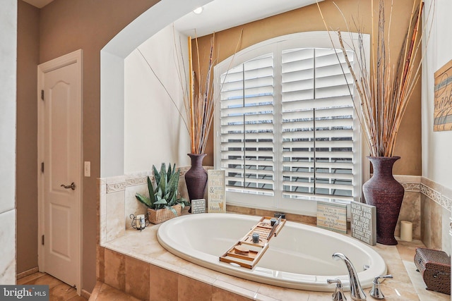 bathroom with tiled bath