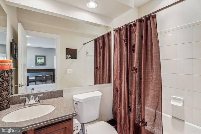 full bathroom with vanity, shower / bath combination with curtain, and toilet