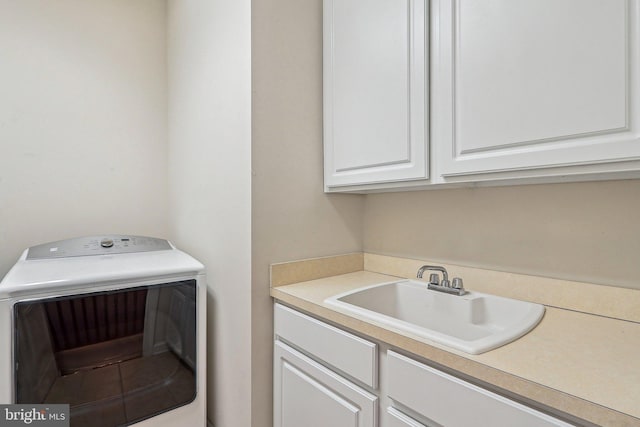 laundry area featuring cabinets, washer / clothes dryer, and sink