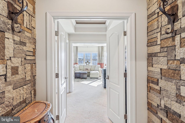 hallway featuring light carpet and ornamental molding