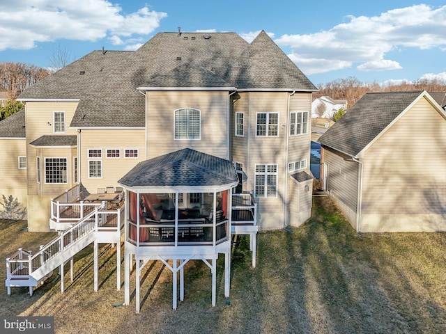 rear view of house with a lawn and a deck