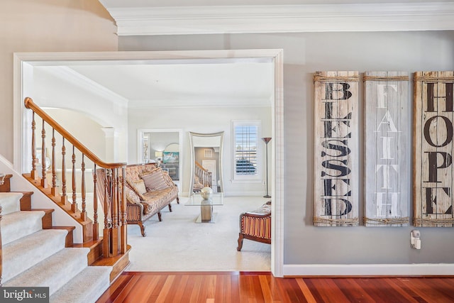 entryway with crown molding, decorative columns, and hardwood / wood-style flooring