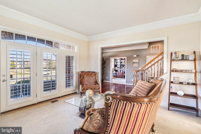 living area with ornamental molding and carpet