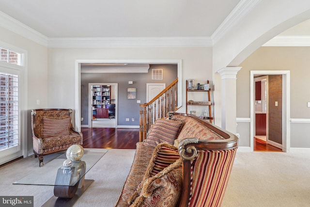 living room featuring crown molding and decorative columns