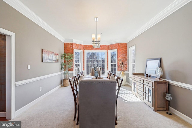 dining room featuring light carpet, a notable chandelier, and crown molding