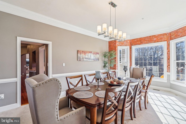 carpeted dining area featuring an inviting chandelier and crown molding