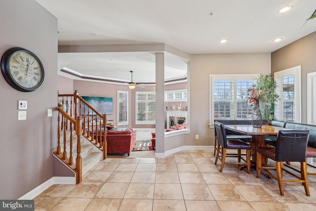 tiled dining area with ceiling fan